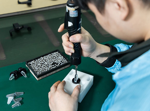 a worker is assembling a plastic part